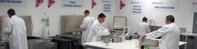 Technicians at work in the lab using the Fireline Ultrasonic cleaning system